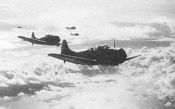 Yorktown SBD-3 dive bombers return to their carrier after striking Japanese shipping in Tulagi harbor.