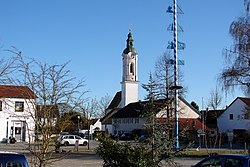 Market square with the Church of Saint John the Baptist and maypole