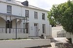 This double storeyed semi-detached complex, with its Georgian and Victorian features, dates from the years 1890-1900. The property forms and integral part of the historic core of Paarl.