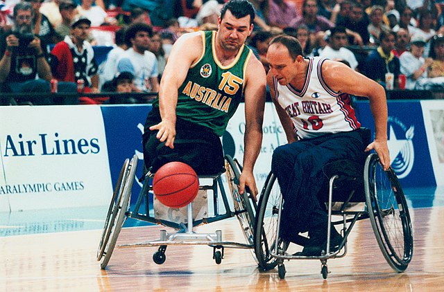 Australian wheelchair basketballer Orfeo Cecconato takes on a Great Britain defender in the final of the men's wheelchair basketball tournament at the