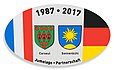 Autocollant édité en 2017 à l'occasion du trentième anniversaire du jumelage de Corseul, dans les Côtes d'Armor, avec Sonnenbühl, dans le land du Bade-Wurtemberg en Allemagne.