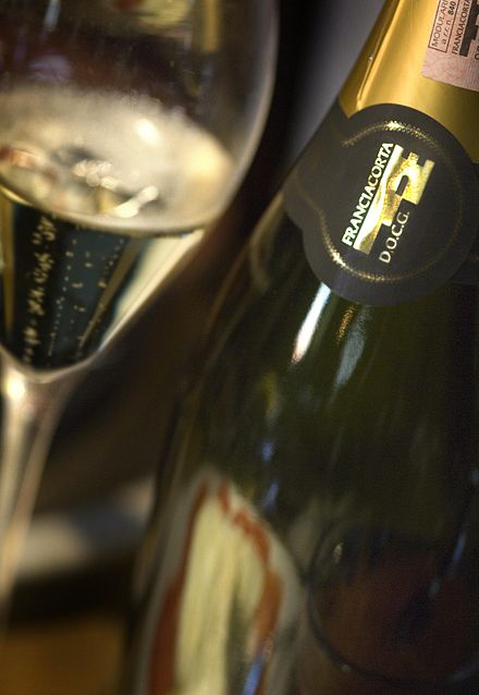 A bottle displaying the Franciacorta DOCG logo seal