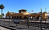 A yellow Mission-style railroad station building