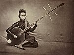 Cambodian musician playing Chapey in 1880