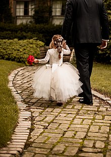 Flower girl wearing the popular Anagrassia flower girl dress: a lace bodysuit with big tulle skirt Flower girl in tutu dress and lace leotard with grandfather.jpg
