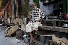 Old food seller in his corner shop Varanasi Benares India
