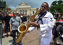 A US Seventh Fleet Band sailor with a tenor saxophone in Hong Kong Jarell Harris playing saxophone in Disneyland Hong Kong (40714629233).jpg