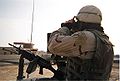 A US soldier on a vehicle with a mounted M249