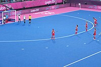 A view of the penalty circle (solid line), the broken circle 5 m from it, and the penalty spot. London Olympics Hockey GB vs Japan.jpg
