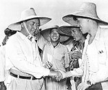 Mao Zedong shaking hands with a people's commune farmer