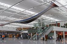 Check-in area at Terminal 2; the notable hanging sculpture advertising BMW has since been removed. Munich (- Franz Josef Strauss) (MUC - EDDM) AN0517640.jpg