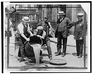 New York City Deputy Police Commissioner John A. Leach, right, watching agents pour liquor into sewer following a raid during the height of prohibition LCCN99405169.jpg