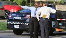 Oklahoma City Police Department detectives in "plainclothes" attire investigating a homicide crime scene Oklahoma City Police Homicide Detectives.jpeg