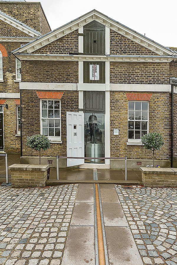 The building housing the origin of the Greenwich Prime Meridian, marked by the brass strip in the foreground. The apex of the roof opens up above the 
