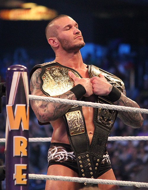 Randy Orton unified the World Heavyweight Championship (left) and WWE Championship (right) as the WWE World Heavyweight Championship.