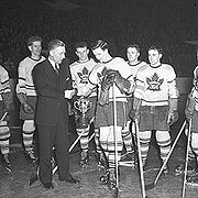Photo of Red Dutton presenting the Calder Memorial Trophy.