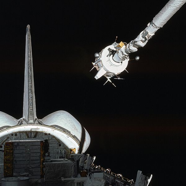 The Plasma Diagnostics Package (PDP) is grappled by the shuttle's Remote Manipulator System (Canadarm).