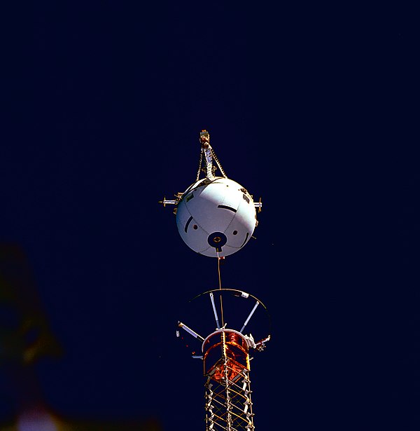 Medium close-up view, captured with a 70 mm camera, shows tethered satellite system deployment.