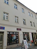 Residential house in closed development, with two side wings in the courtyard and remains of the medieval city wall