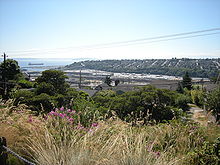 The former Smith Cove tideflats seen from Soundview Terrace on Queen Anne Hill. The hill in the background is part of Magnolia. The former tideflats lie between the two hills. Seattle - former Smith Cove tideflats from Soundview Terrace 01.jpg