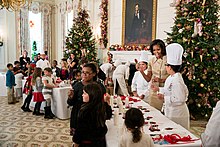 White House executive chef Cris Comerford and children make White House honey tea stirrers, Nov 28, 2012 State Dining Room of the White House during the Christmas holiday press preview, Nov. 28, 2012.jpg