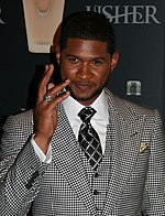 R&B singer Usher broke Billboard records with four number-one singles for 28 weeks on the top spot in a calendar year. Usher Ring (cropped).jpg