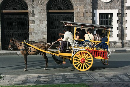 A tartanilla in Intramuros. These originate from the American colonial-era and differ in that they have two side-facing benches instead of forward-facing passenger seats.