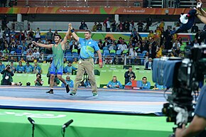 Sharifov announces the victory of Ihtiyor Novruzov at the 2016 Olympic Games. His rival from Mongolia refused to attend the winner's announcement ceremony in protest