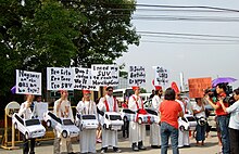 Protesters rallied in front of the Senate against the bishops that allegedly accepted money and luxury cars from former president Gloria Macapagal Arroyo in exchange for support (Pajero Bishop Scandal) Filipinos protest against the Bishops that allegedly accepted money and luxury cars from former president Macapagal-Arroyo in exchange for support.jpg