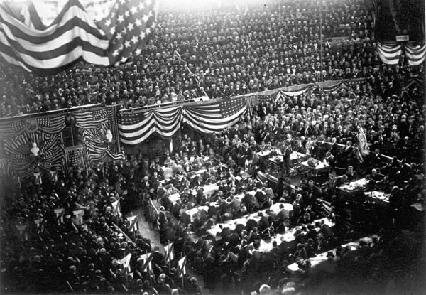 A view inside the Interstate Exposition Building (known as the "Glass Palace") during the convention; James Abram Garfield (center, right) is on the podium, waiting to speak.