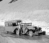 1929-30 Graham-Paige with early mobile camper trailer at Glacier National Park; December, 1933