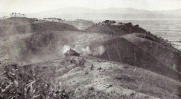 Infantry deployed on the crest of hill, while in the background a tank provides support.