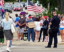 A man holds a "Free Kyle" sign near Bradford High School during President Donald Trump's visit on September 1, 2020. A Kyle Rittenhouse supporter in Kenosha Wisconsin.jpg