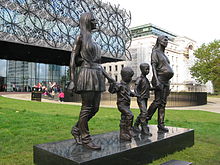 The artwork, with the Library of Birmingham (left) and Baskerville House in the background A Real Birmingham Family.JPG