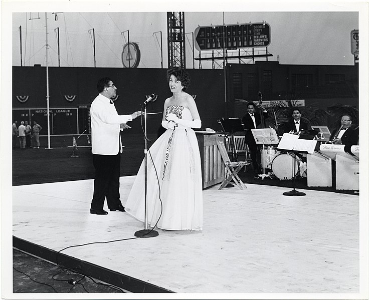 File:A man conducts a band as a woman sings in Fenway Park (12618992073).jpg