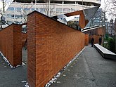 Amsterdam, the new Holocaust Namenmonument with its red walls of named bricks along the street Weesperstraat; free photo Amsterdam city by Fons Heijnsbroek, 9 April 2022