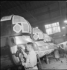 Spray painters at work in the paint shop of the Handley Page's Cricklewood factory, 1942