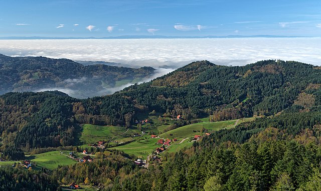 The Black Forest is a large forested mountain range in the state of Baden-Württemberg in southwest Germany, bounded by the Rhine Valley to the west an