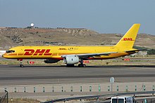 Side view of yellow twin-engine jet on tarmac.