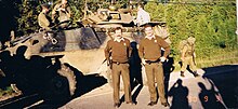 Canadian Forces personnel pictured behind two civilians of the Surete du Quebec during the Oka Crisis in 1990. Crise d'Oka - SQ et forces canadiennes.jpg