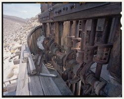 DETAIL OF STAMP BATTERIES CAMS, TAPPETS AND STEMS WITH SIX FOOT SCALE, LOOKING NORTH NORTHWEST. SEE CA-290-24 FOR IDENTICAL BandW NEGATIVE. - Skidoo Mine, Park Route 38 (Skidoo HAER CA-290-48 (CT).tif