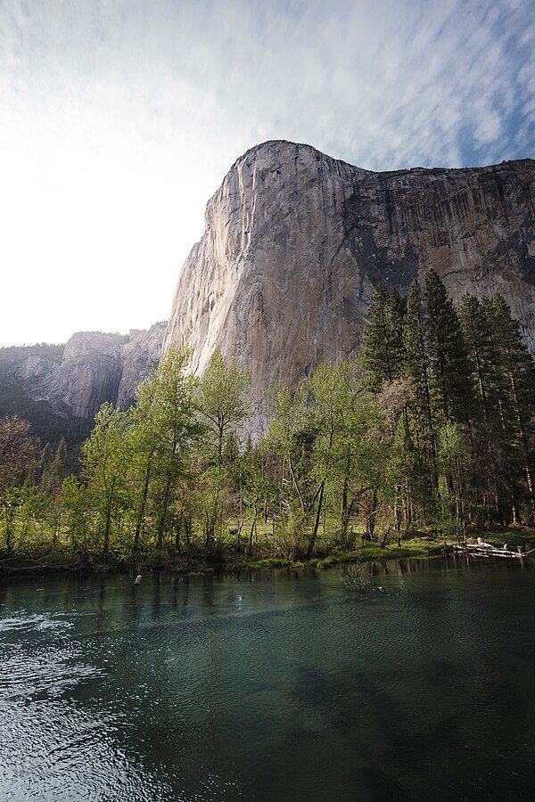 Southwest face (left, in light) and southeast face (right, in shade) of El Capitan from Yosemite Valley; the Nose lies between the two faces