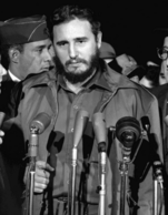 Fidel Castro is pictured speaking into several microphones