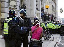 An injured protester with police medics G20 injured protester and police.jpg