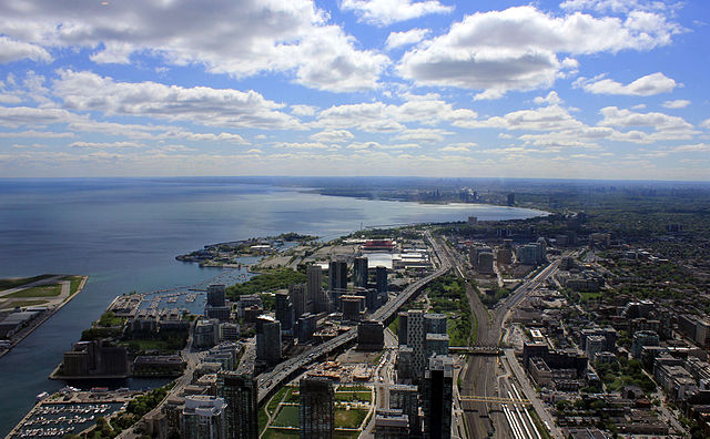 View of Exhibition Place, looking west from the CN Tower in 2013. The site is situated in center distance, left (south) of the elevated freeway, start