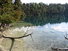 Deadman's Point at Green Lake. Marl reef, bacteria formed chalky shoreline formations, are visible in the foreground.