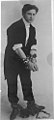 Harry Houdini, full-length portrait, standing, facing right, in chains LCCN96518790.jpg