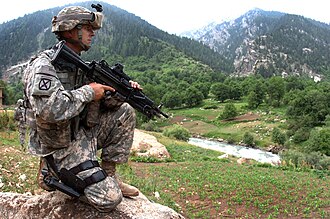 An Army National Guardsman of the 1st Battalion, 151st Infantry Regiment in Parun, Afghanistan. Note that he is wearing a 10th Mountain Division Former Wartime Service SSI. M249 with Mk46 stock.jpg