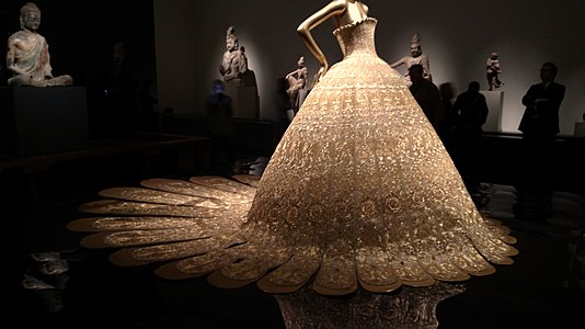A silk couture dress by Chinese designer Guo Pei became a center piece of the exhibition[12][13]