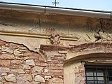 Čeština: Dekor nad vchodem kostela sv. Bartoloměje v Nečemicích. Okres Louny, Česká republika. English: Stucco decoration uppon the main entrance of the Church of Saint Bartolomew in Nečemice village, Louny District, Czech Republic.